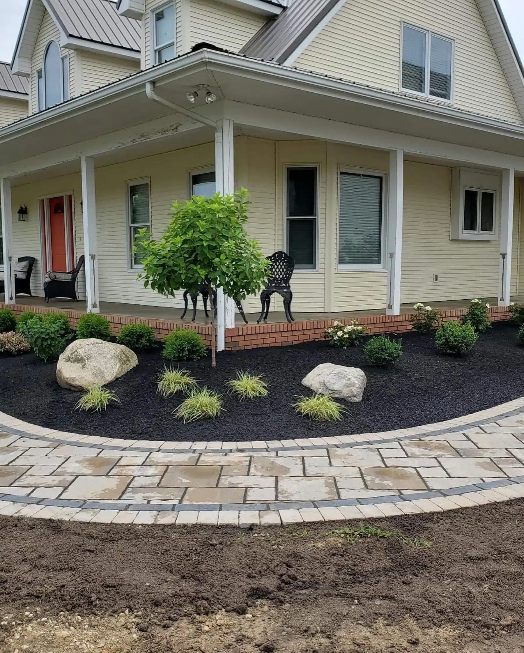 a house with a patio and a stone walkway
